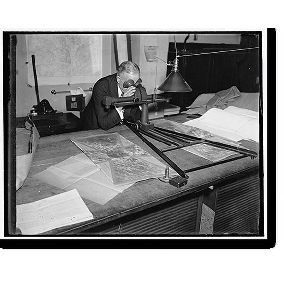 Historic Print, Geological Survey. Washington, D.C., March 13. Albert Pike using a stereoscope on a pair of photographs to bring out the relief and locate objects for a map, 18" x 24"