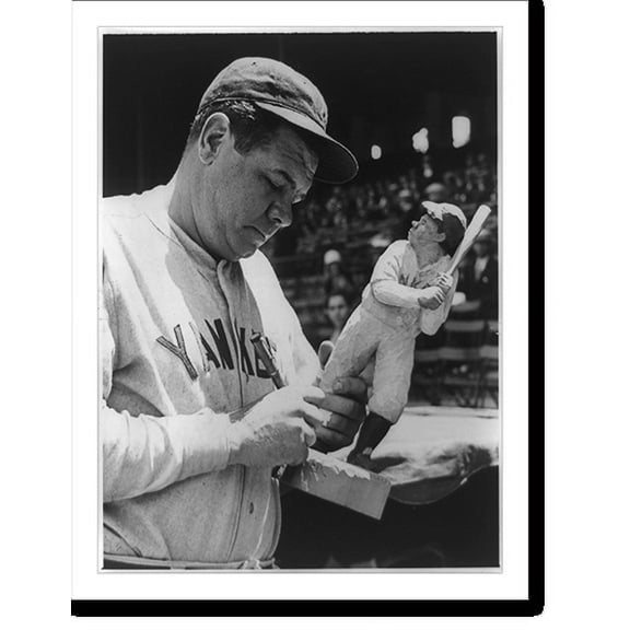 Historic Print, [George Herman Ruth, half-length portrait, standing, facing right, autographing wooden statue of himself by Carl Hallsthammar], 18" x 24"