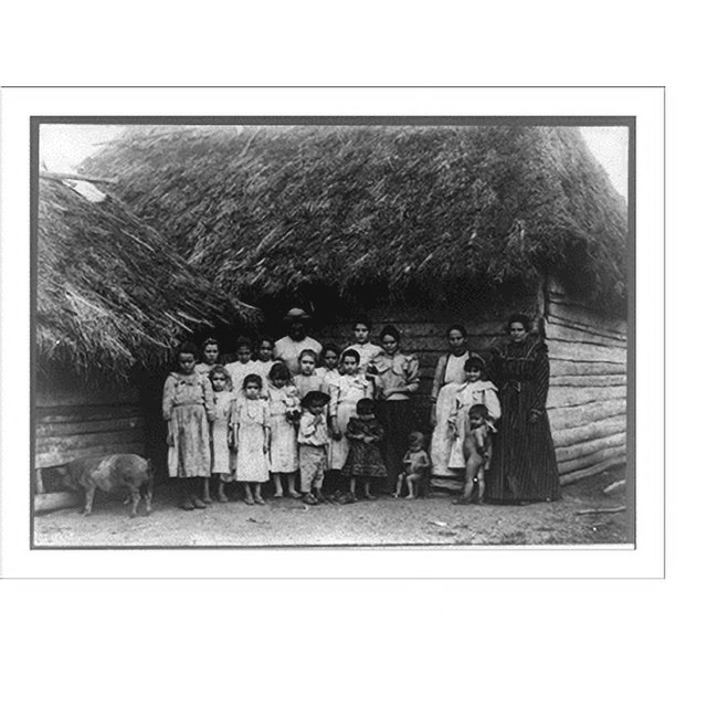 Historic Print, [Group of natives posed standing in front of thatched