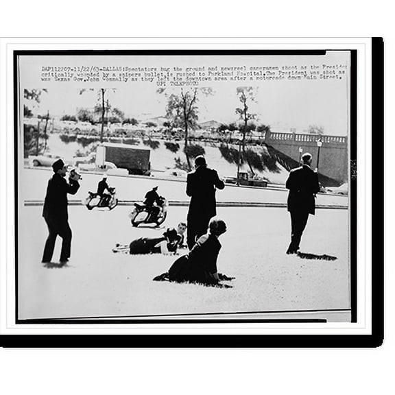 Historic Print, [In the aftermath of President John F. Kennedy's assassination two policemen on motorcycles pass by, while spectators lay on the ground, three photographers record the s…16" x 20"