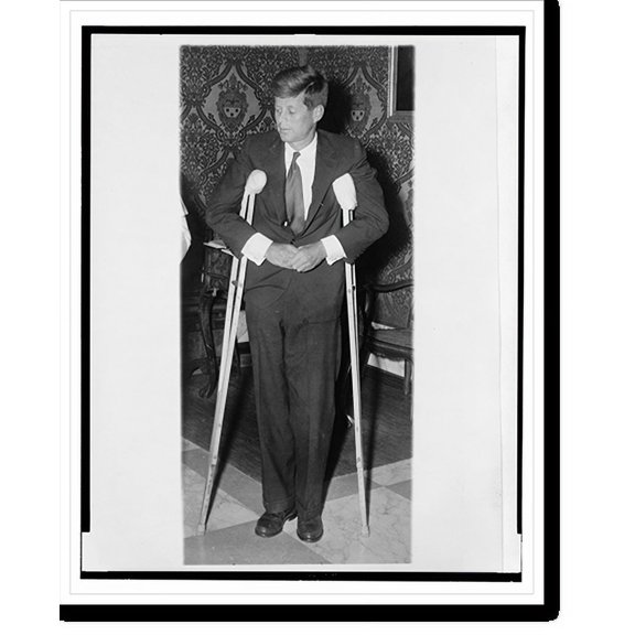Historic Print, [John F. Kennedy, full-length portrait, standing with crutches, facing slightly left], 16" x 20"
