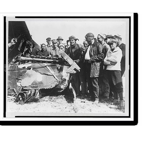 Historic Print, [Lieut. R.A. Kenlock and John Brockhurst, a movie camerman from International, examining a broken bit of the fuselage of an airplane they were in, which was in an accide...18" x 24"
