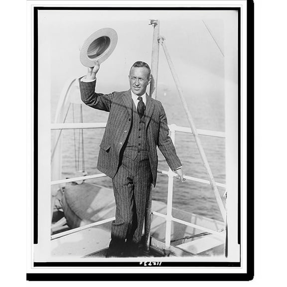 Historic Print, [Lincoln Ellsworth, full-length portrait, standing on boat, facing slightly left, holding up hat], 16" x 20"