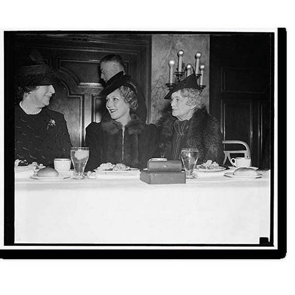 Historic Print, Mary Pickford breaks bread with cab wives at newspaper women's luncheon. Washington, D.C., Nov. 15. Mrs. Cordell Hull and Mrs. Claude A. Swanson, right, wife of Secretar...18" x 24"