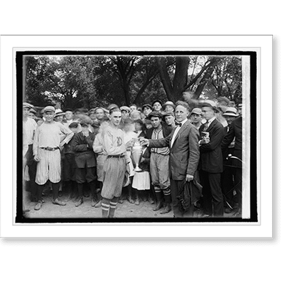 Historic Print, [Member of sports team receiving trophy], 16" x 20"