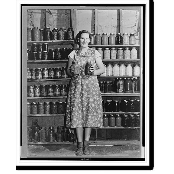 Historic Print, Mrs. Alfred Peterson, wife of tenant purchaser borrower, with preserved food. Mesa County, Colorado, 16" x 20"