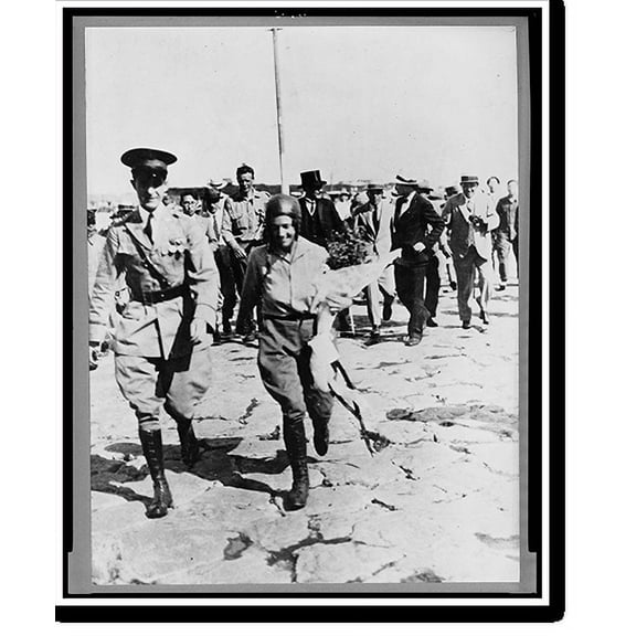 Historic Print, [Mrs. Anne Morrow Lindbergh being escorted by Japanese officer, with the colonel, her husband, in background, after their arrival at Nemuro, Japan], 16" x 20"