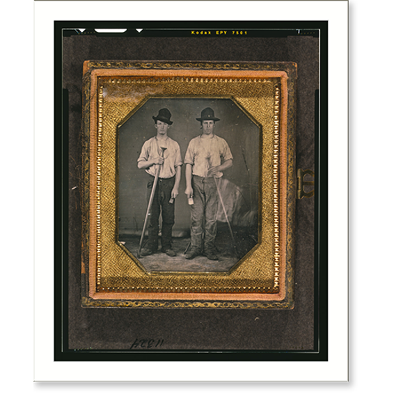Historic Print, [Occupational portrait of two men, standing full length holding floor rammers, foundry tools used for packing sand against molds], 16" x 20"