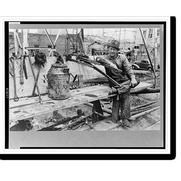 Historic Print, Oil field worker resting on pipe wrench, Kilgore, Texas, 18" x 24"