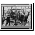 Historic Print, Oil roughnecks screwing one piece of drill pipe to