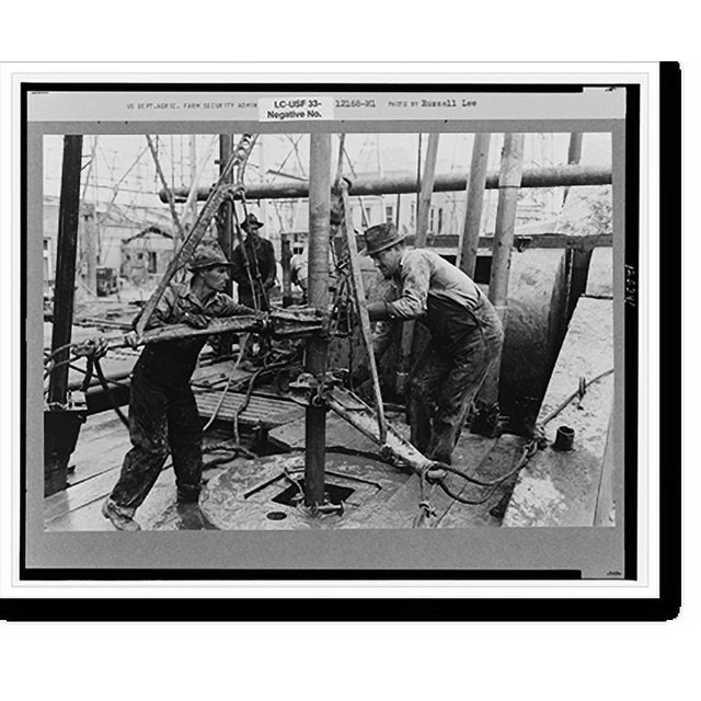 Historic Print, Oil roughnecks screwing one piece of drill pipe to