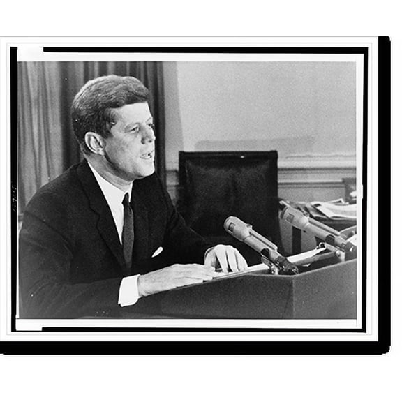 Historic Print, [President John F. Kennedy, head-and-shoulders portrait, facing right, behind podium with microphones, addressing the American people with news that the U.S. is setting ...18" x 24"