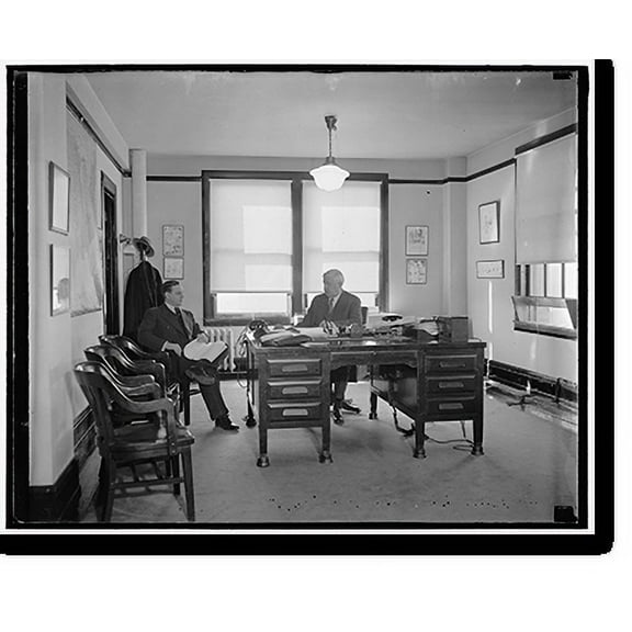 Historic Print, RFC Head at Work. Washington, D.C. Jesse Jones, Chairman of the Reconstruction Finance Corporation, at work in his office today. George Butler, of Houston, Texas, is sho...18" x 24"