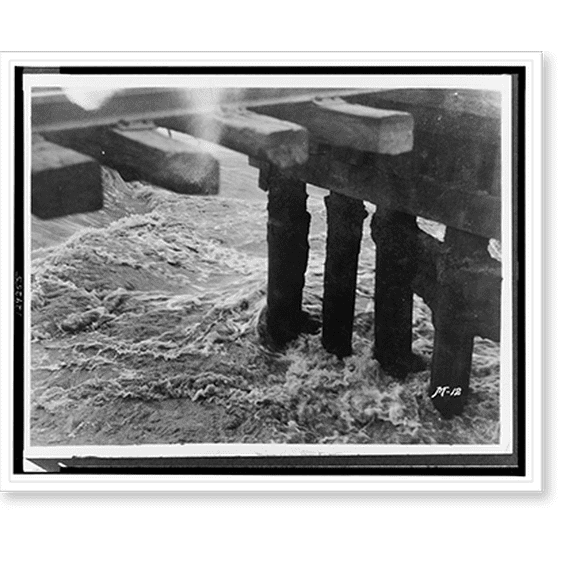 Historic Print, [Raging floodwaters pass through a bridge trestle], 16" x 20"