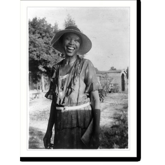 Historic Print, [Smiling woman, three-quarter-length portrait of unidentified person standing outdoors], 18" x 24"