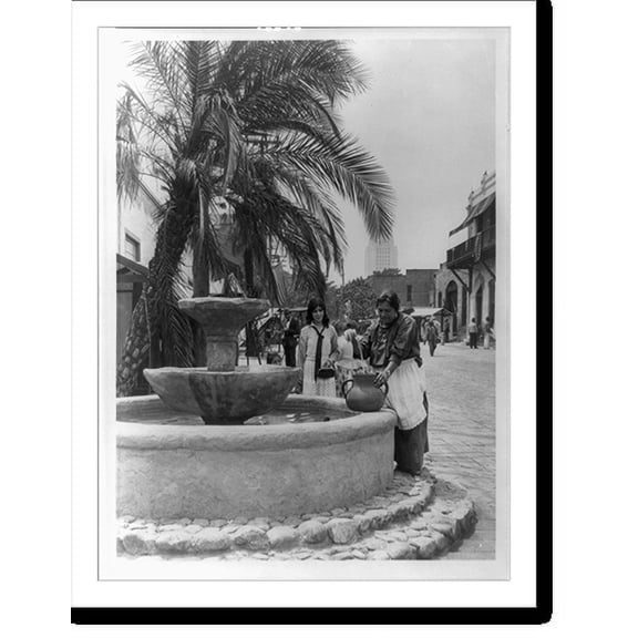Historic Print, [Spanish-American woman getting water at a fountain on Olvera Street, Mexican shopping lane, Los Angeles, California, with tower of City Hall in background], 16" x 20"