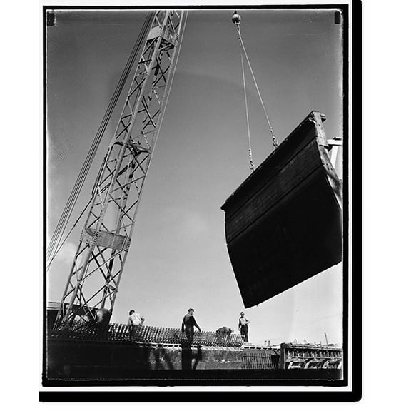Historic Print, Swinging a form for the concrete high speed basin into place. The workmen are standing in the place where the unique concrete hinges of the arched roof will be, 16" x 20"