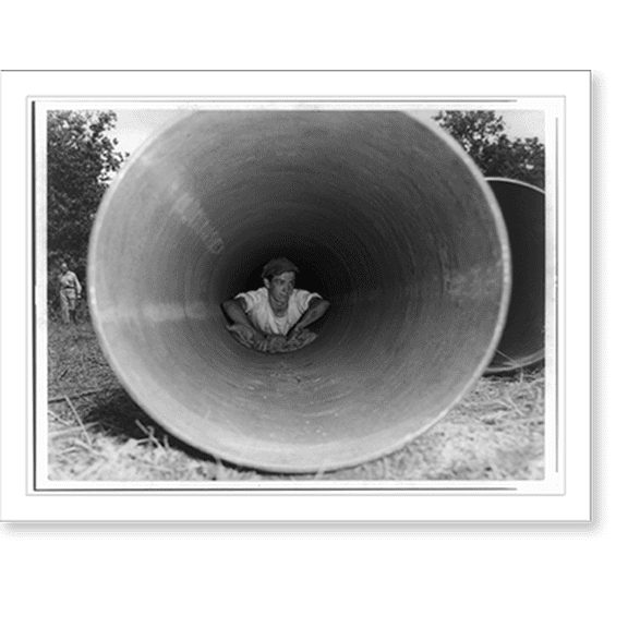 Historic Print, [The Big Inch pipeline under construction: Man cleaning pipe from inside before the welders join the pipe], 18" x 24"