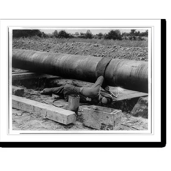 Historic Print, [The Big Inch pipeline under construction: Man welding pipe], 18" x 24"