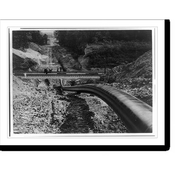 Historic Print, [The Big Inch pipeline under construction: The pipe going under railroad and up hill], 16" x 20"