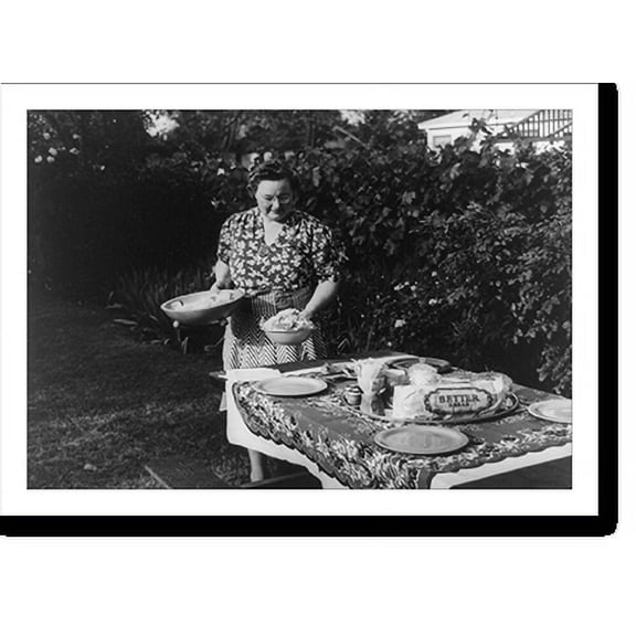 Historic Print, Turlock, California. Housewife serves dinner in the backyard of her home. Menu: barbecued steaks, fresh peas, potato salad, potato chips, celery and olives, strawberry s...18" x 24"
