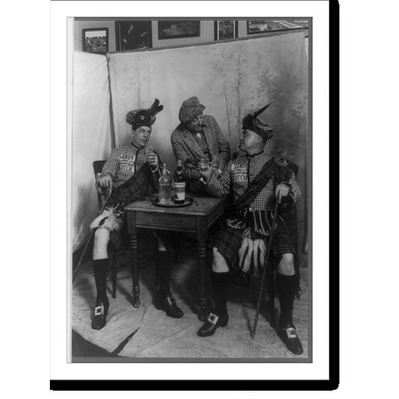 Historic Print, [Two men wearing kilts seated at small table, drinking Sandy MacDonald scotch, with man standing and leaning against the table], 16" x 20"