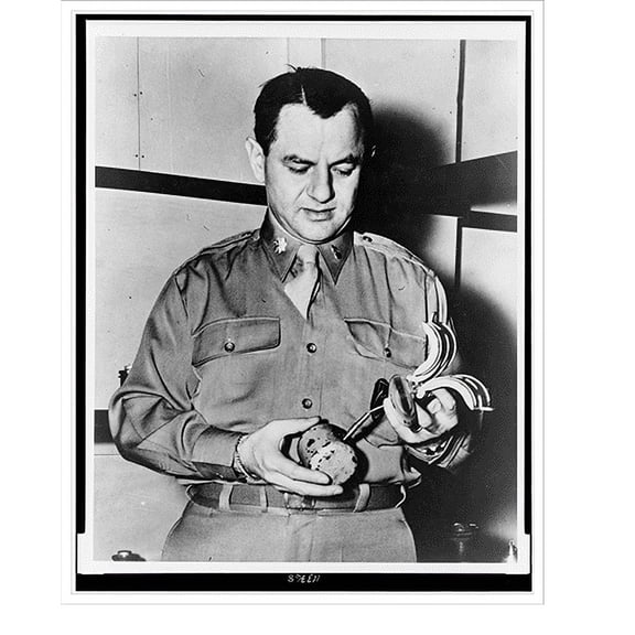 Historic Print, [U.S. Army Major Martin L. Ehrmann, Commandant of Bomb Disposal School at Aberdeen Proving Ground, Md., examines German butterfly" bomb]", 16" x 20"