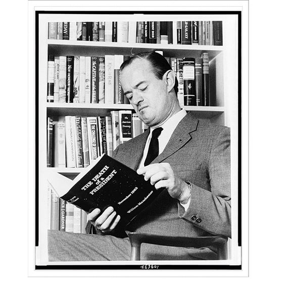 Historic Print, [William Manchester, half-length portrait, seated, facing left, holding a copy of his book, The death of a president"]", 18" x 24"