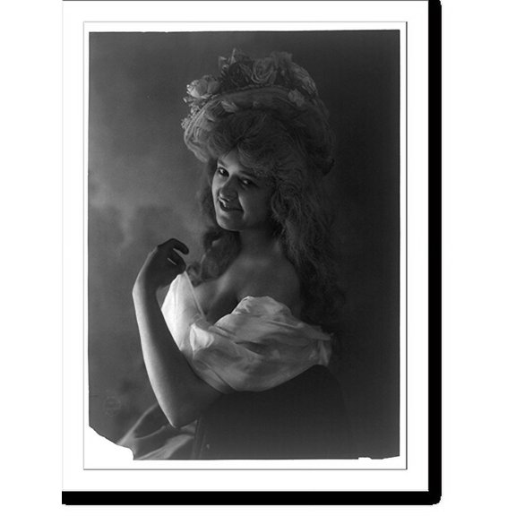 Historic Print, [Young woman modeling: half lgth., facinag left, wearing low-cut dress and hat with flowers], 16" x 20"