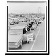 thumbnail image 1 of Historic Print, The masked Operation Breathe Free" motorcade prior to departure from South Beach, S.I..World Journal Tribune photograph by Matthew Black.", 16" x 20", 1 of 3