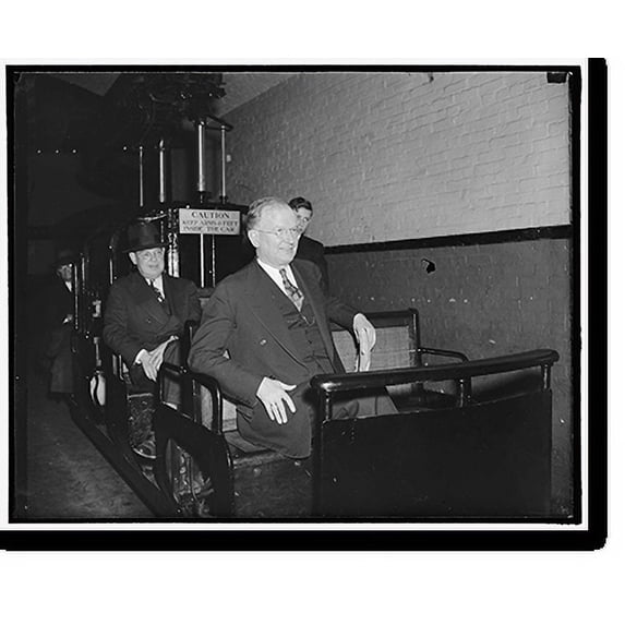 Historic Print, No rail troubles here. Washington, D.C., Feb. 10. Apparently no rail troubles in the Senate subway indicates Senator Burton K. Wheeler as he rides the tram car between t…16" x 20"