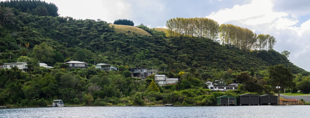 Homes along edge of Lake Tarawera Rotorua District Bay of Plenty North Island New Zealand Canvas Art - Panoramic Images (12 x 30)