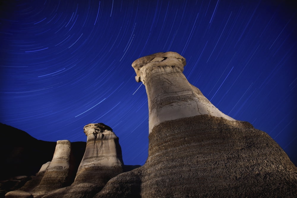 Hoodoos And Star Trails In The Sky Drumheller Alberta Canada Canvas Art - Richard Wear Design Pics (40 x 26)