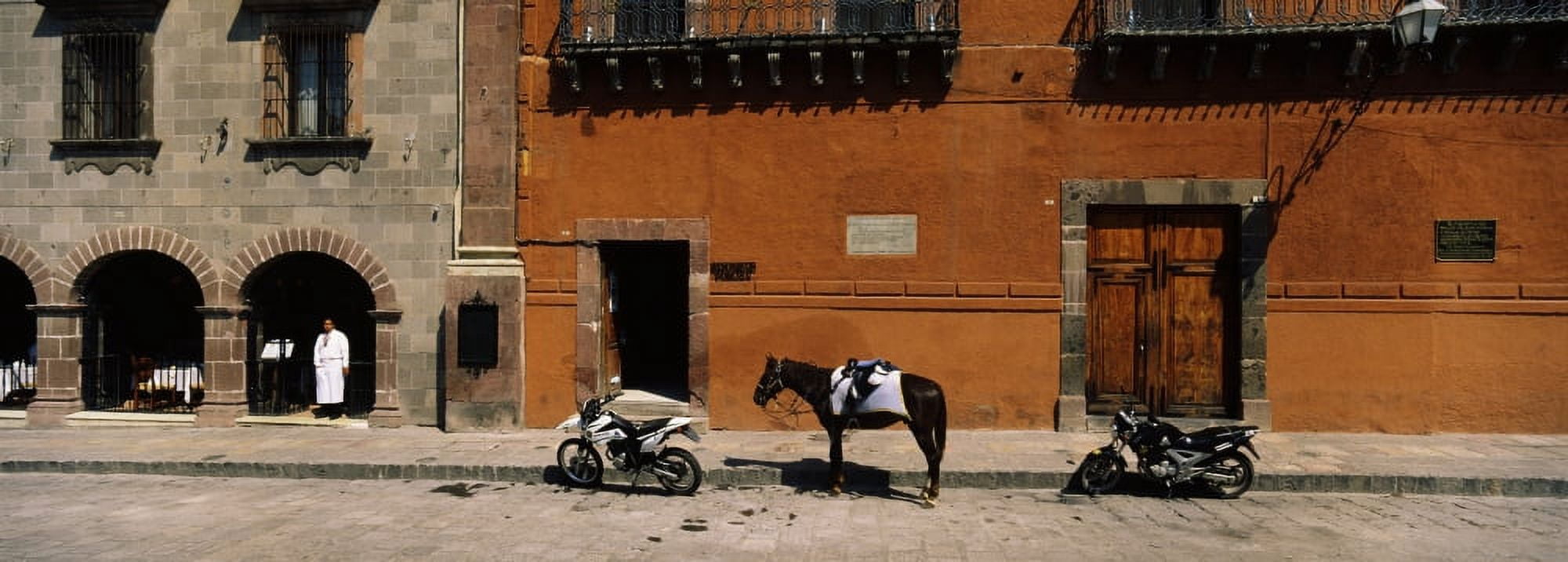Horse standing between two motorcycles parked on a road San Miguel De Allende Guanajuato Mexico Canvas Art - Panoramic Images (27 x 9)