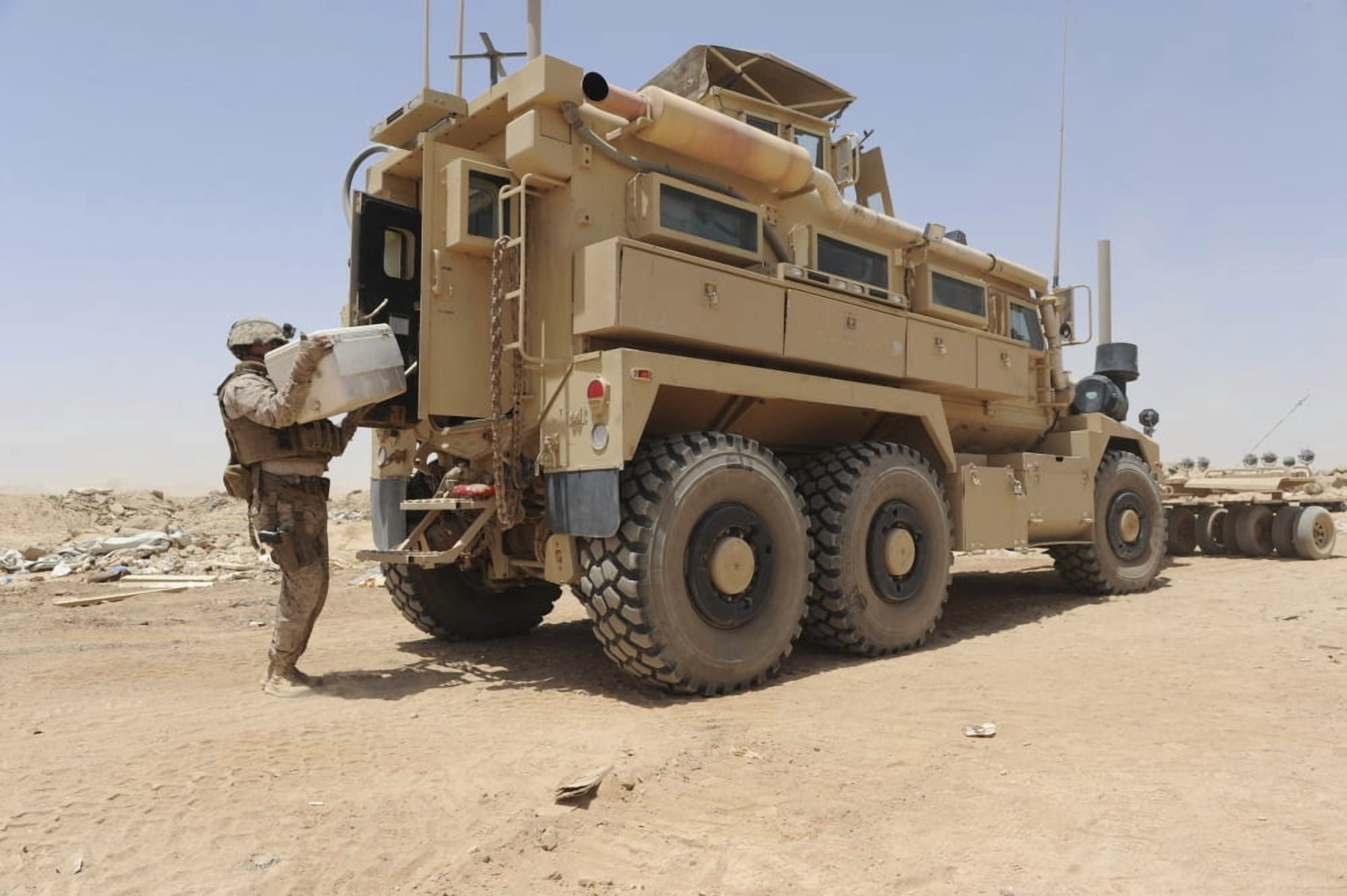 Hospital Corpsman loads up a Mine Resistant Ambush Protected vehicle Canvas Art - Stocktrek Images (35 x 23)