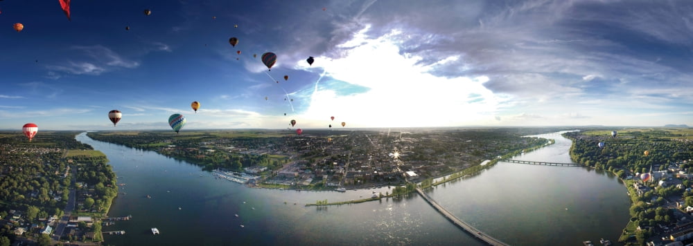 Hot air balloons flying over a river Saint-Jean-sur-Richelieu Quebec Canada Canvas Art - Panoramic Images (36 x 12)
