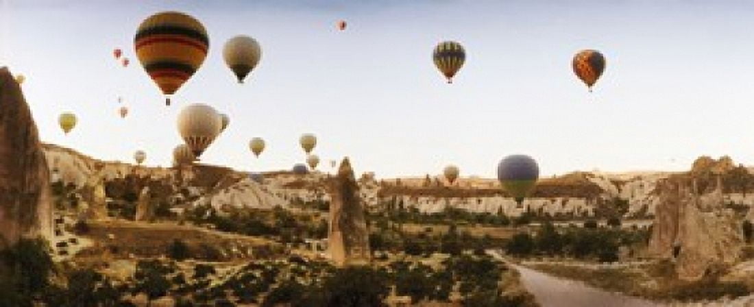 Hot air balloons over landscape at sunrise Cappadocia Central Anatolia Region Turkey Canvas Art - Panoramic Images (15 x 6)