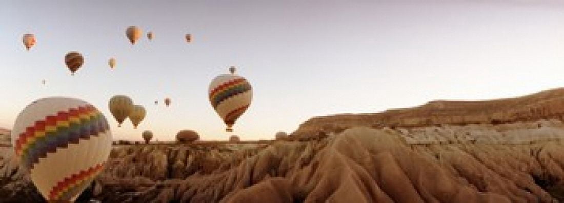 Hot air balloons over landscape at sunrise Cappadocia Central Anatolia Region Turkey Canvas Art - Panoramic Images (36 x 13)