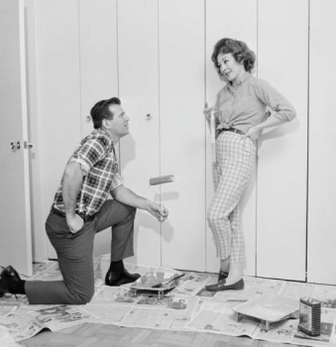 House husband painting closet door while housewife is watching Canvas Art - (24 x 36)