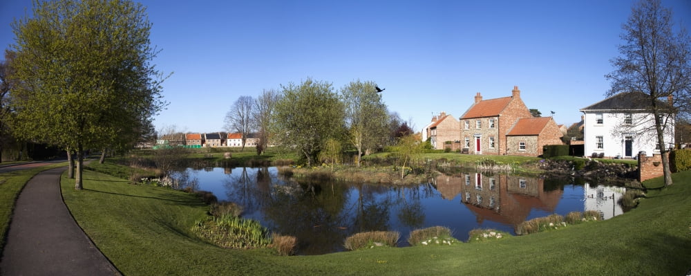 Houses Reflected In A Tranquil Pond East Witton Yorkshire England Canvas Art - John Short Design Pics (44 x 18)