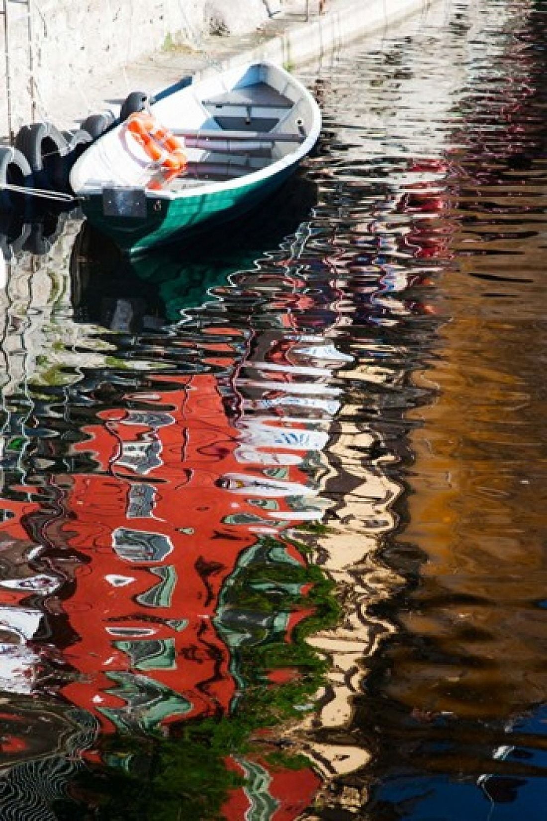 Houses and boat reflected in Lake Como Varenna Lombardy Italy Canvas Art - Panoramic Images (24 x 36)