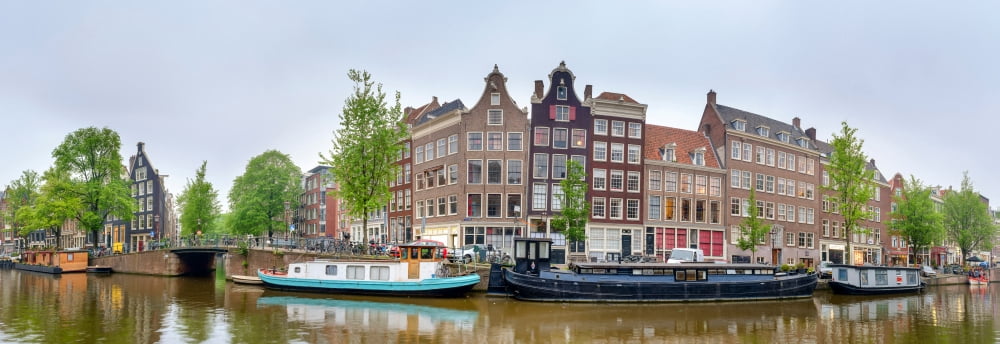 Houses and canal boats along the Prinsengracht Amsterdam North Holland Netherlands Canvas Art - Panoramic Images (36 x 12)