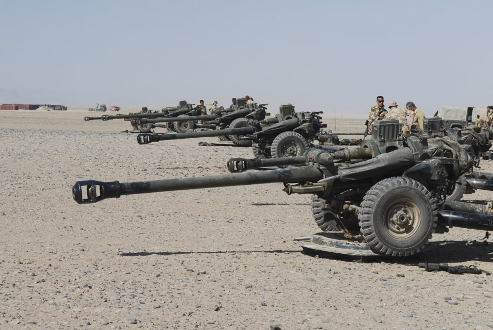 Howitzer 105mm light guns are lined up at Camp Bastion Afghanistan Canvas Art - Andrew ChittockStocktrek Images (17 x 12)