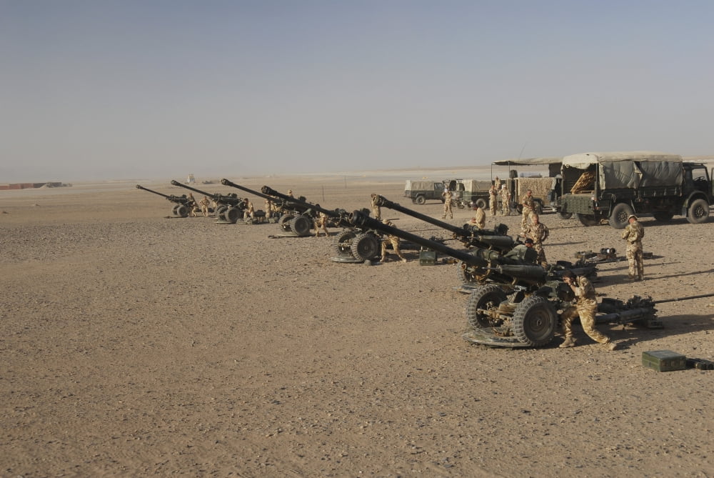 Howitzer 105mm light guns are lined up at Camp Bastion Afghanistan Canvas Art - Andrew ChittockStocktrek Images (34 x 23)