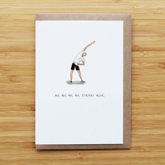 Humorous card with stretching figure illustration and "staying alive" text, perfect for encouraging friends on birthdays or fitness milestones.