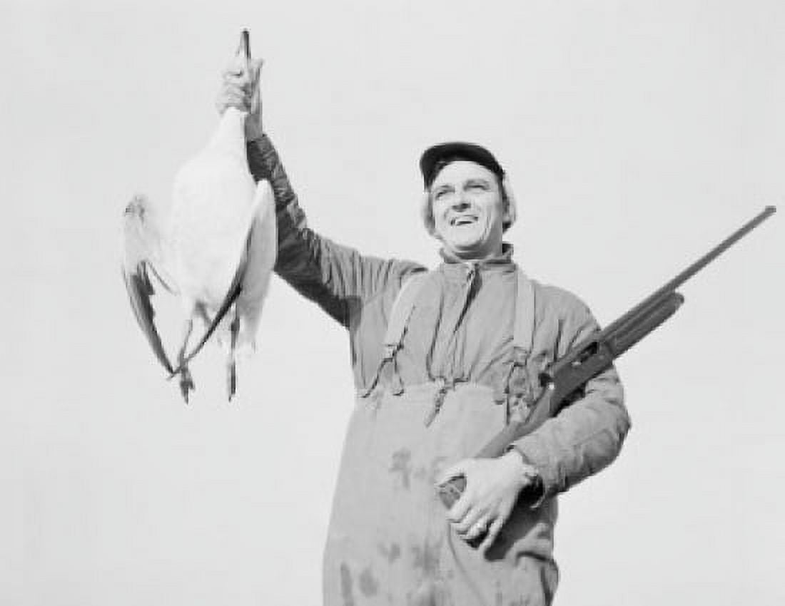 Hunter holding dead snow goose Canvas Art - (24 x 36)