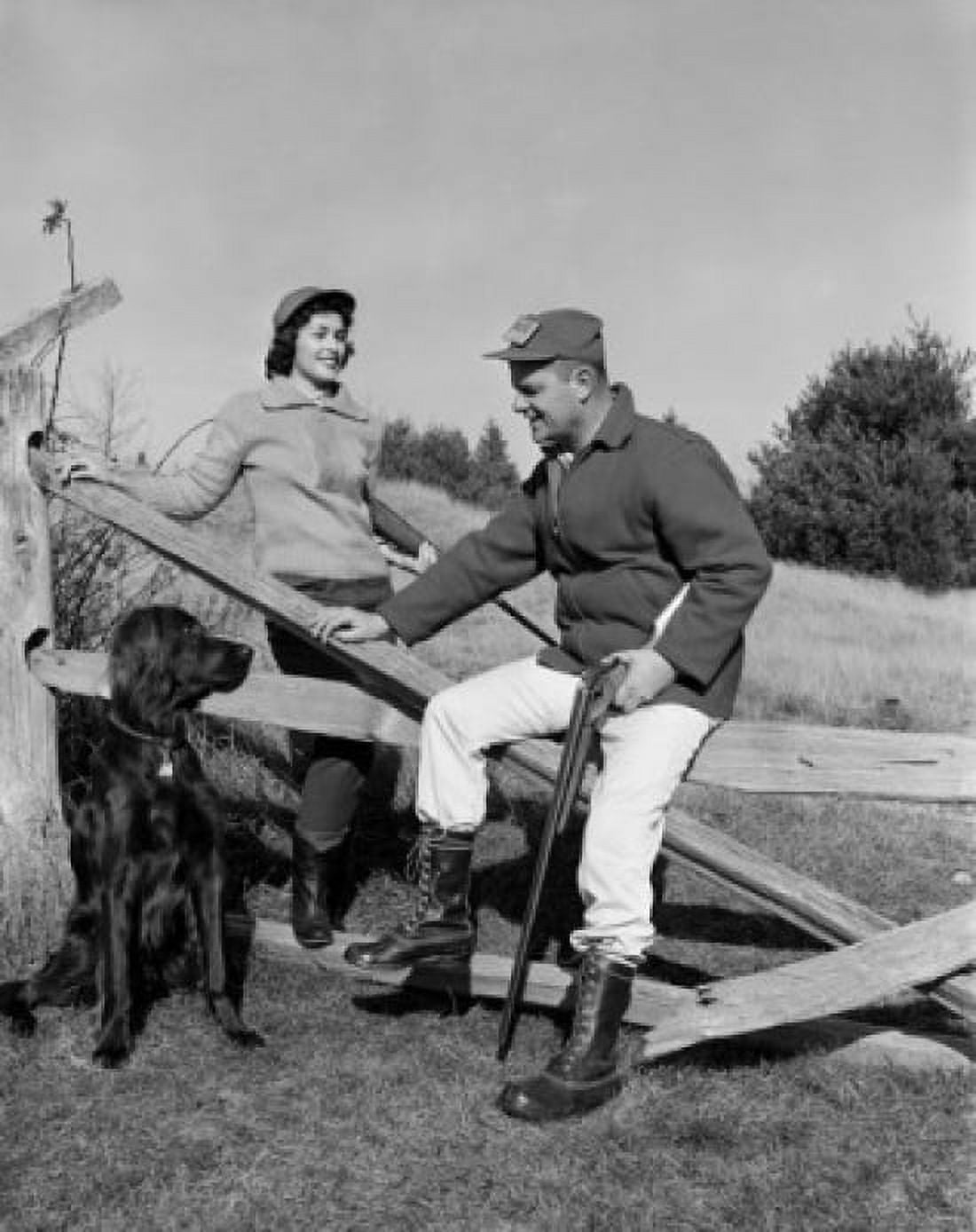 Hunting couple with gun dog relaxing on fence Canvas Art - (24 x 36)