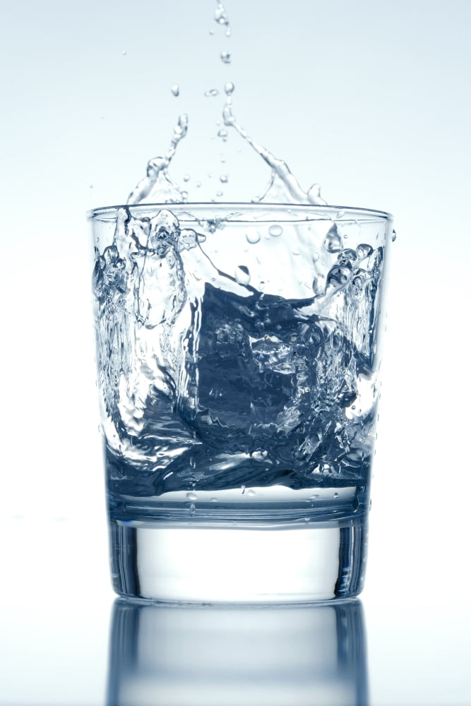 Ice Cube Falling into a Glass of Water Splashing Surface Canvas Art - Panoramic Images (27 x 9)