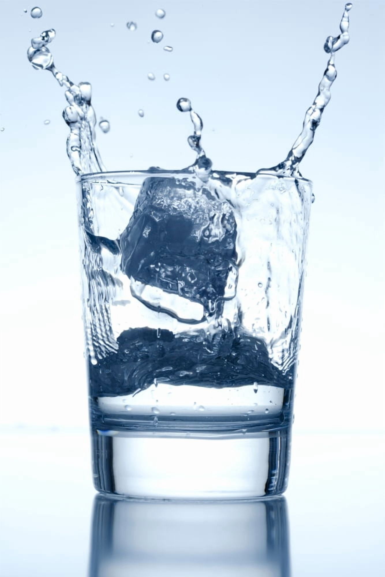 Ice Cube Falling into a Glass of Water Splashing Surface Canvas Art - Panoramic Images (36 x 12)