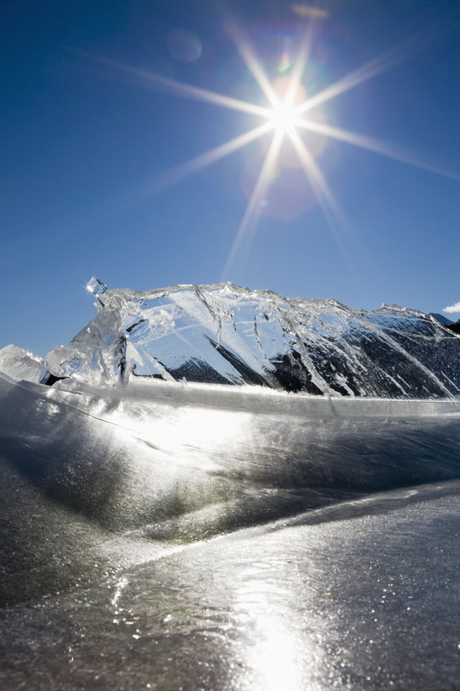 Ice Formations On A Frozen Lake Shoreline In The Mountains With A Sunburst And Blue Sky Alberta Canada Canvas Art - Michael Interisano Design Pics (12 x 19)